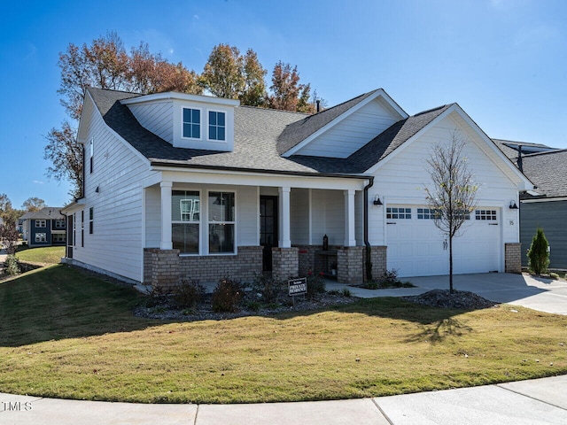 craftsman-style house featuring a garage, a front lawn, and a porch