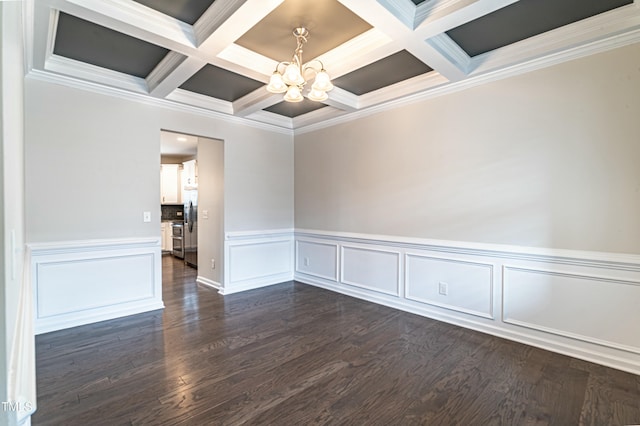 empty room with a notable chandelier, beam ceiling, crown molding, and coffered ceiling