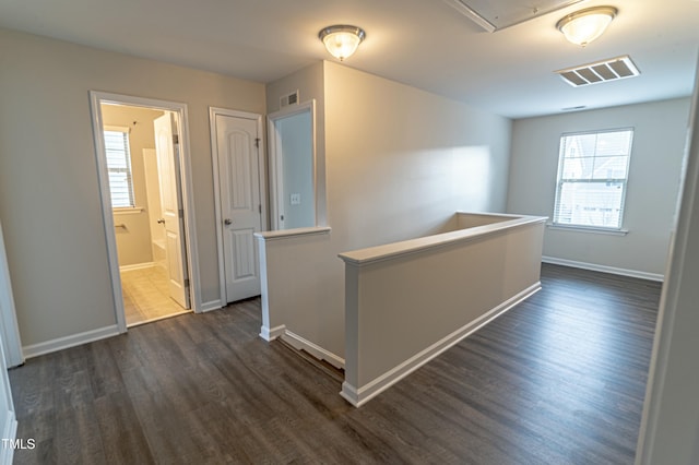 corridor featuring dark hardwood / wood-style floors