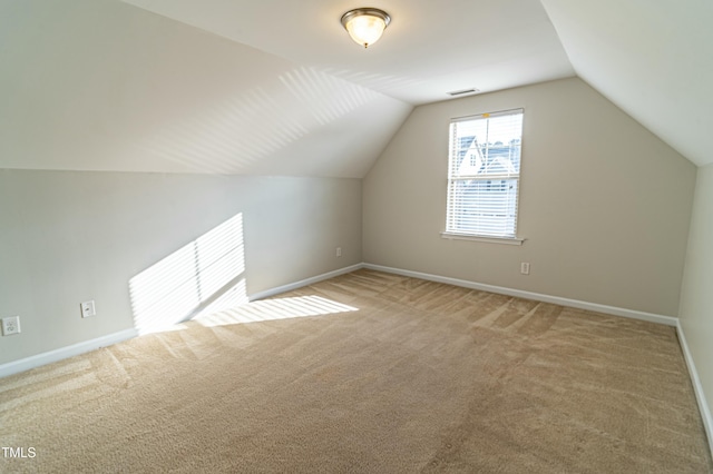 bonus room with carpet floors and vaulted ceiling