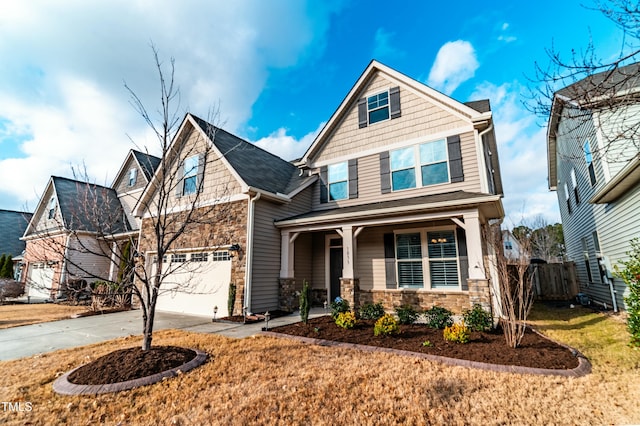 craftsman inspired home with covered porch, a garage, and a front yard