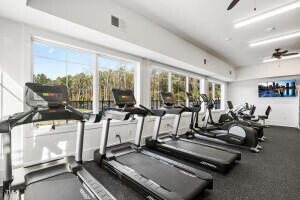 exercise room with ceiling fan and plenty of natural light