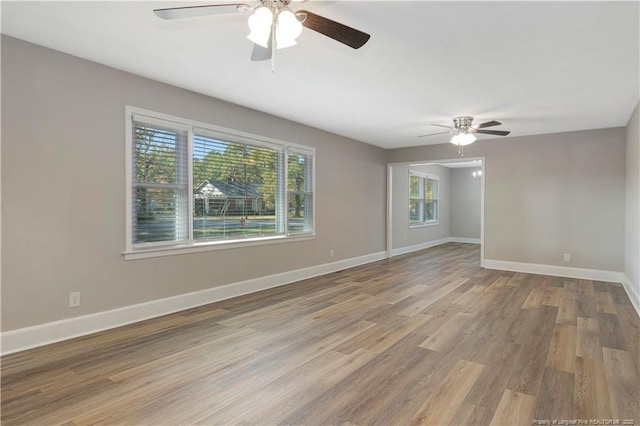 empty room featuring hardwood / wood-style flooring and ceiling fan