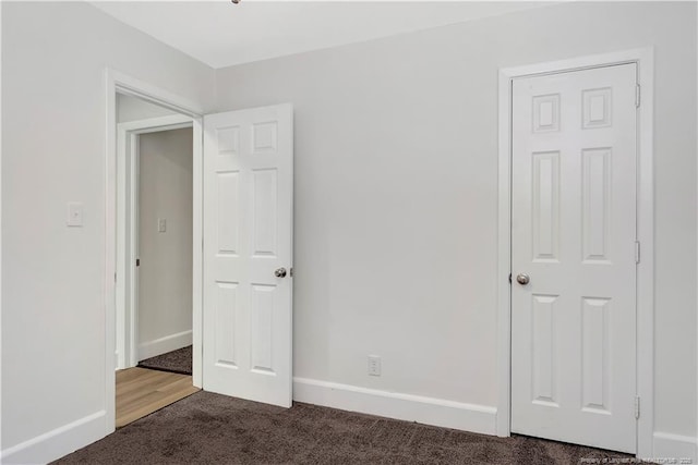 unfurnished bedroom featuring dark colored carpet