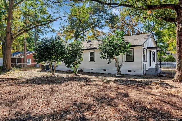 view of side of home featuring central AC