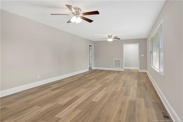 unfurnished room with ceiling fan and light wood-type flooring