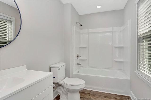 full bathroom with shower / tub combination, vanity, toilet, and hardwood / wood-style floors