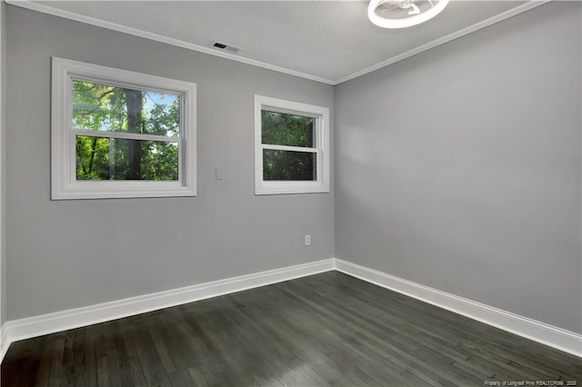 spare room with crown molding and dark wood-type flooring