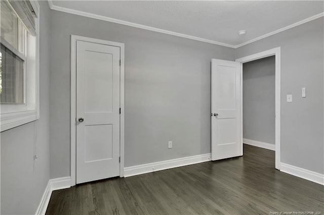 unfurnished bedroom with dark hardwood / wood-style floors and ornamental molding