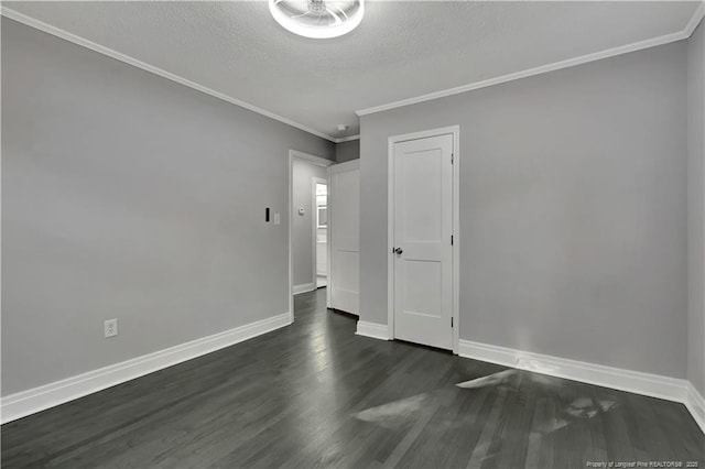 unfurnished room featuring crown molding, dark wood-type flooring, and a textured ceiling