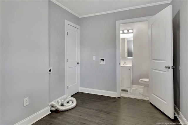 interior space with dark hardwood / wood-style flooring, connected bathroom, ornamental molding, and sink