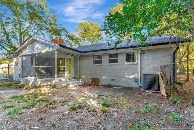 back of house featuring a sunroom and central air condition unit