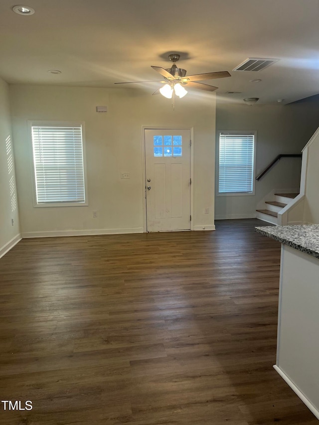 entryway with dark wood-type flooring and ceiling fan