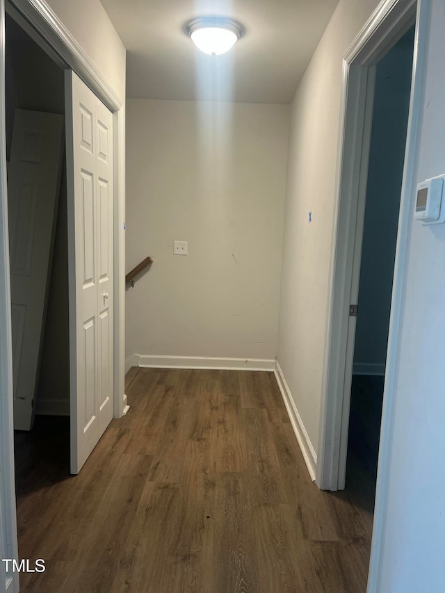 hallway with dark hardwood / wood-style flooring