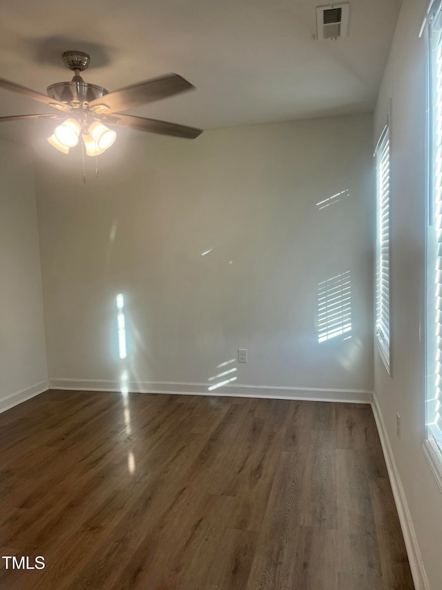 empty room featuring ceiling fan and dark hardwood / wood-style flooring