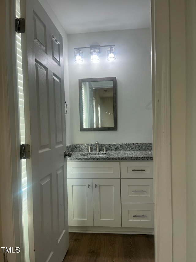 bathroom featuring vanity and hardwood / wood-style flooring