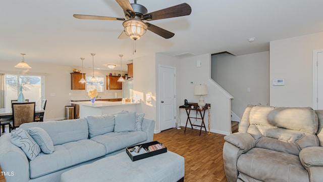 living room featuring light hardwood / wood-style floors and ceiling fan