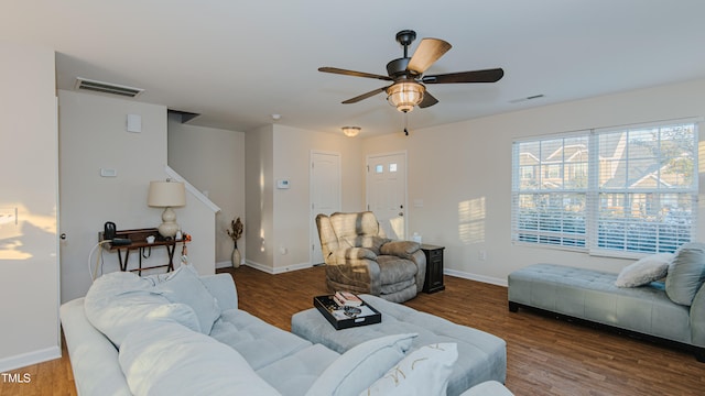 living room featuring wood-type flooring and ceiling fan