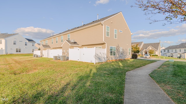 rear view of house featuring a lawn