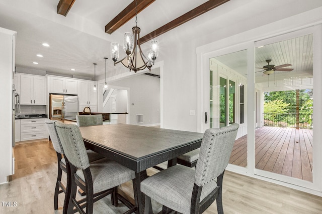 dining space with beamed ceiling, light wood-type flooring, and ceiling fan with notable chandelier