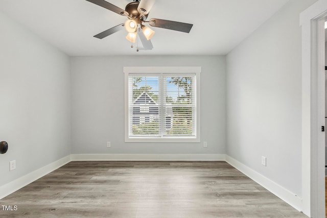 spare room featuring hardwood / wood-style flooring and ceiling fan