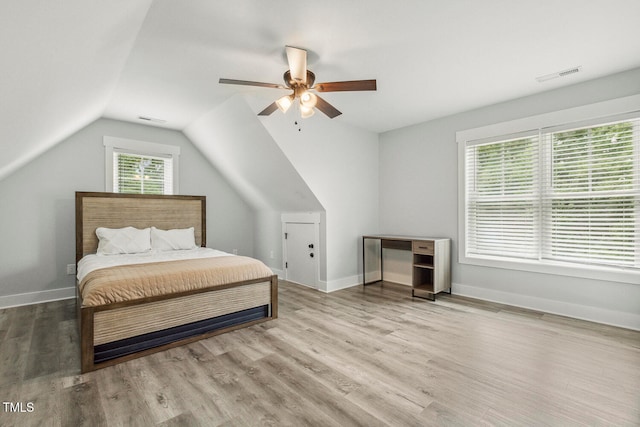 bedroom with light wood-type flooring, lofted ceiling, and ceiling fan