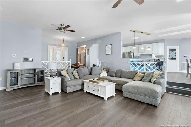 living room with dark wood-type flooring and ceiling fan