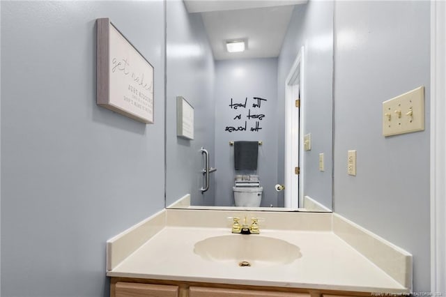 bathroom with toilet and vanity