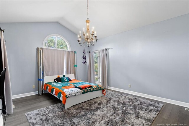 bedroom with a notable chandelier, lofted ceiling, and hardwood / wood-style floors