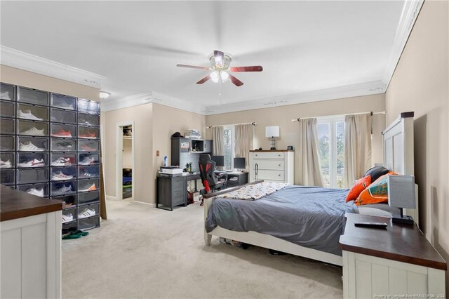 carpeted bedroom with ornamental molding and ceiling fan