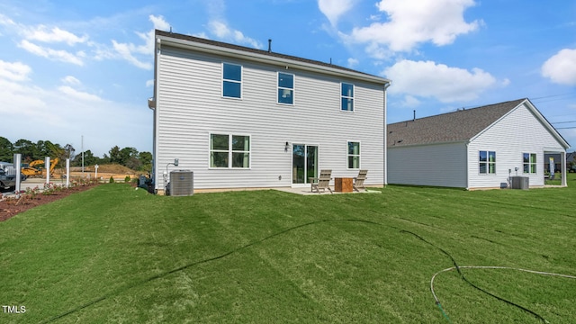 rear view of house featuring a patio area and a yard