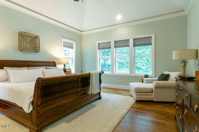 bedroom featuring crown molding, lofted ceiling, and dark hardwood / wood-style floors