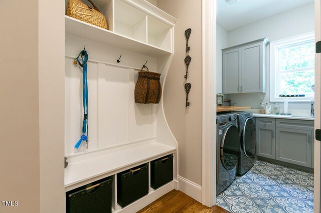 mudroom with independent washer and dryer and hardwood / wood-style flooring