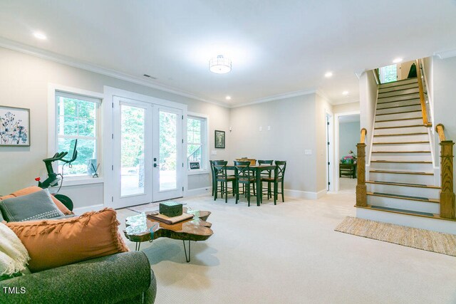 carpeted living room featuring ornamental molding and french doors