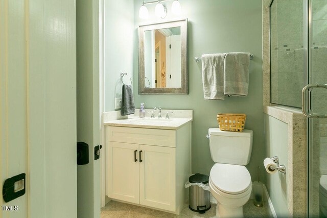 bathroom with toilet, walk in shower, and vanity