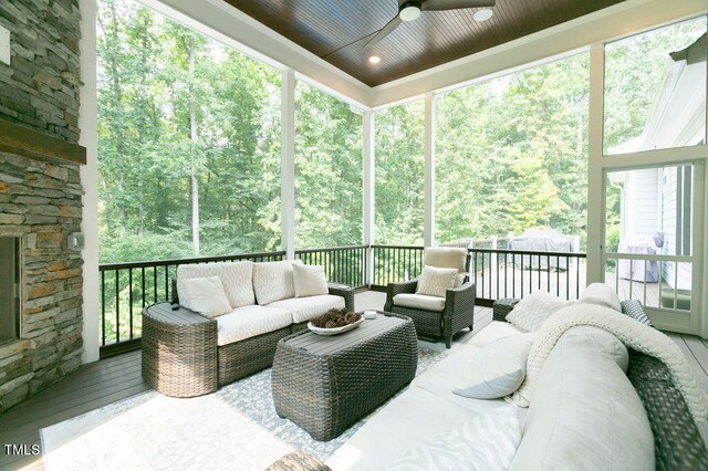 wooden deck featuring outdoor lounge area and ceiling fan