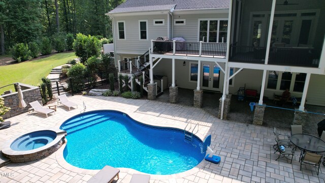 view of swimming pool featuring a patio and an in ground hot tub