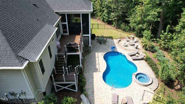 view of swimming pool with a patio, a sunroom, a deck, and a grill