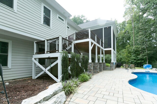 exterior space with a patio and a sunroom