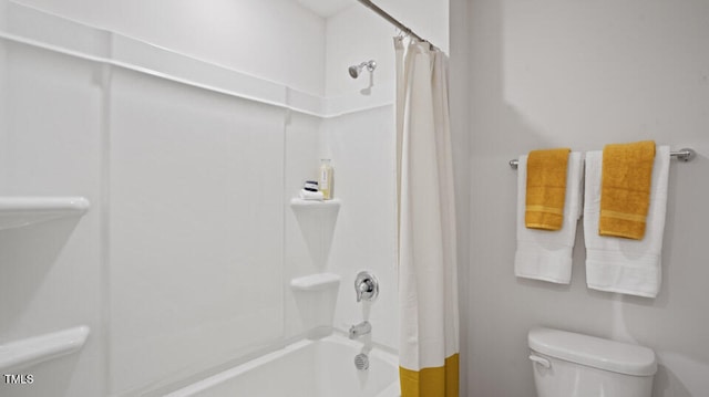 bathroom with toilet and shower / bath combo with shower curtain