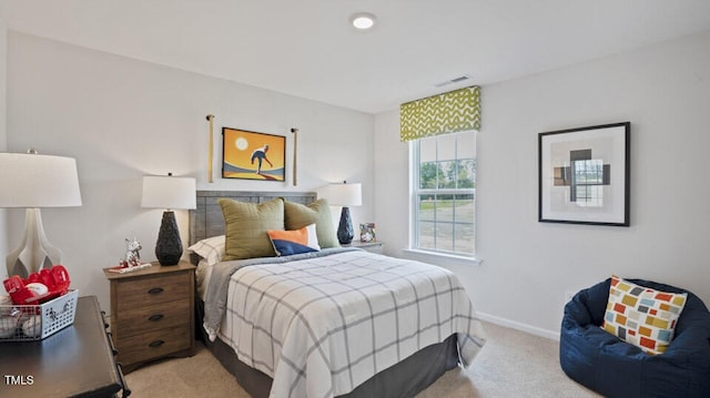 bedroom featuring light colored carpet