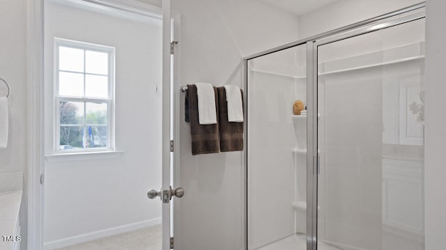 bathroom with a shower with door