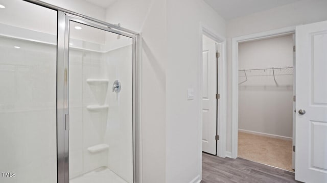 bathroom featuring hardwood / wood-style flooring and walk in shower