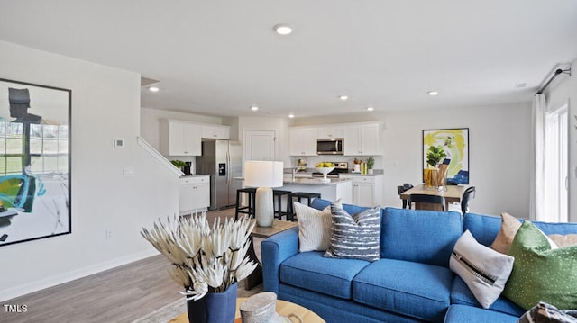 living room featuring light wood-type flooring and a wealth of natural light