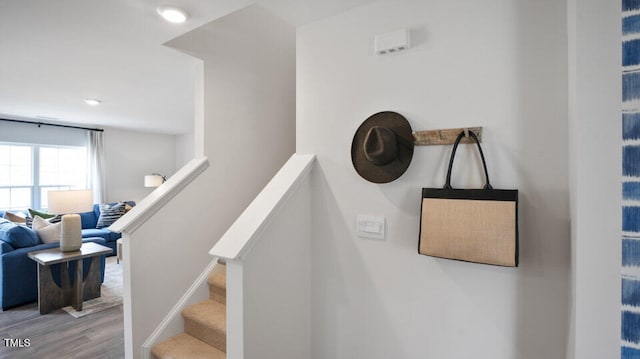 staircase with hardwood / wood-style flooring