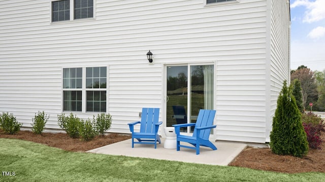 back of house with a patio and a lawn