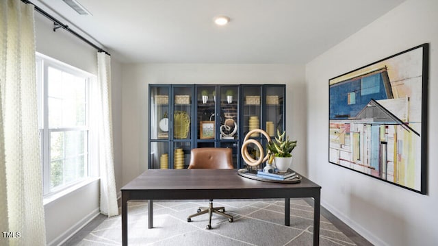 carpeted office space featuring plenty of natural light