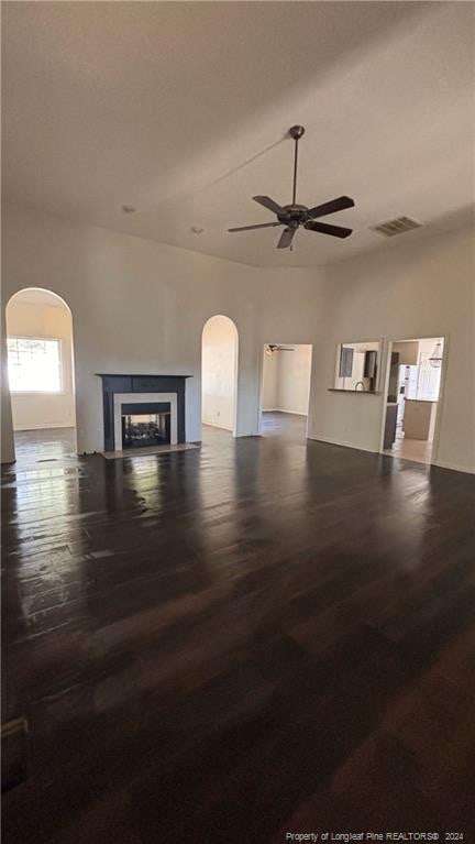 unfurnished living room featuring hardwood / wood-style flooring and ceiling fan