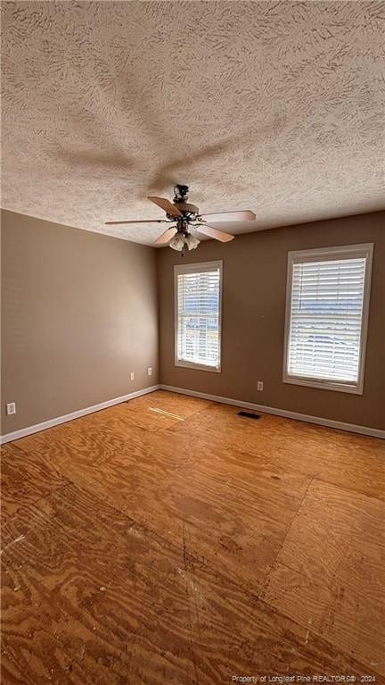 spare room with a textured ceiling and ceiling fan