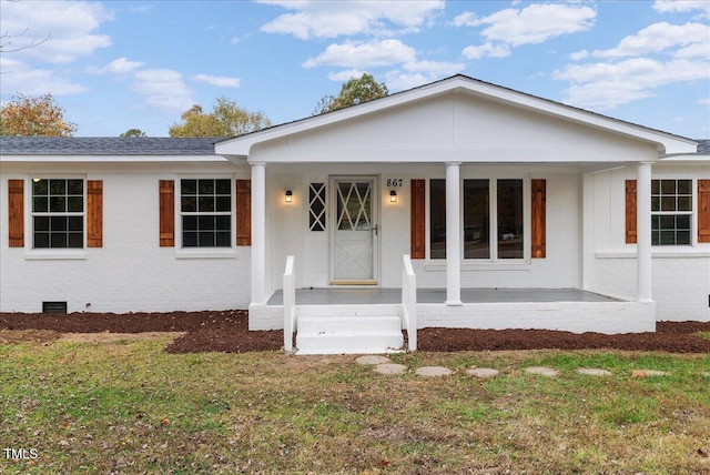 ranch-style home with covered porch and a front lawn